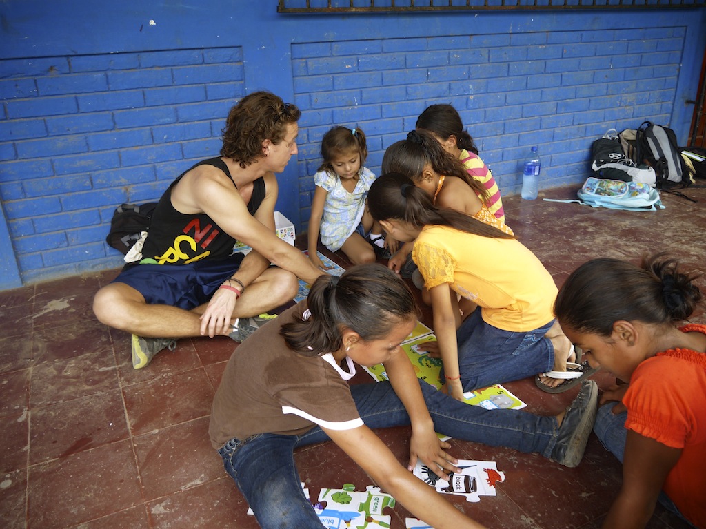 Co founder Matt Wilson putting together puzzles with children from a local school